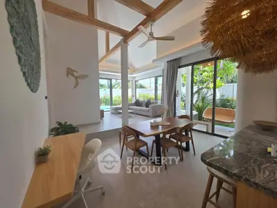 Stunning open-plan living room with natural light and garden view, featuring modern decor and wooden accents.