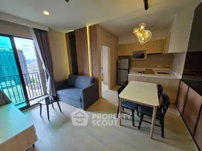 Modern open-layout living room with kitchen, featuring stylish furniture and city view balcony.