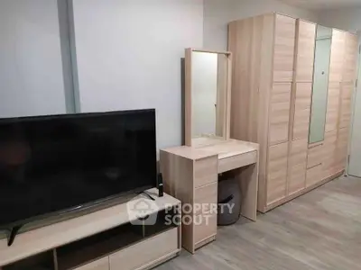 Modern bedroom with sleek wooden furniture and flat-screen TV, perfect for stylish living.