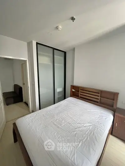 Modern bedroom with sleek sliding door closet and cozy bed setup