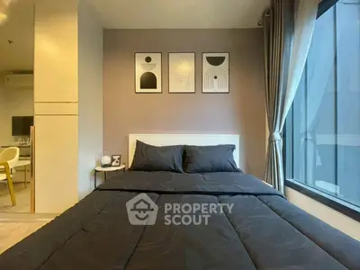 Modern bedroom with stylish decor and large window for natural light