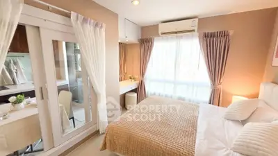 Cozy bedroom with elegant decor and ample natural light, featuring a stylish bed and mirrored wardrobe.