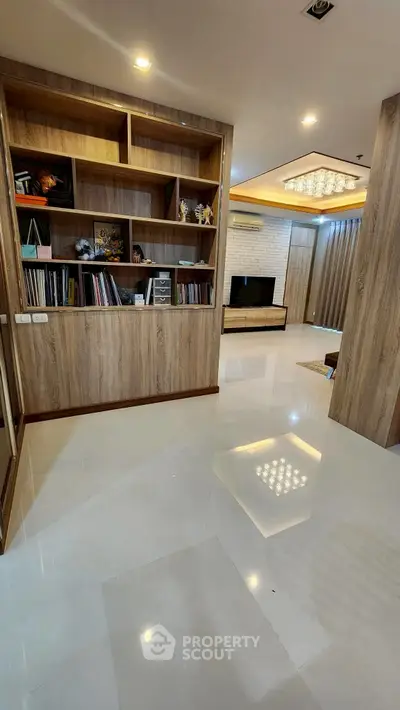 Spacious modern living room with elegant wooden shelving and sleek flooring