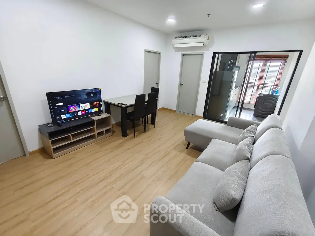 Spacious modern living room with sleek furniture and open layout, perfect for relaxation and entertainment.