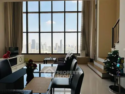 Luxurious high-rise living room with stunning city skyline view.