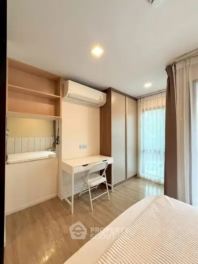 Modern bedroom with sleek design and ample natural light, perfect for relaxation and comfort.