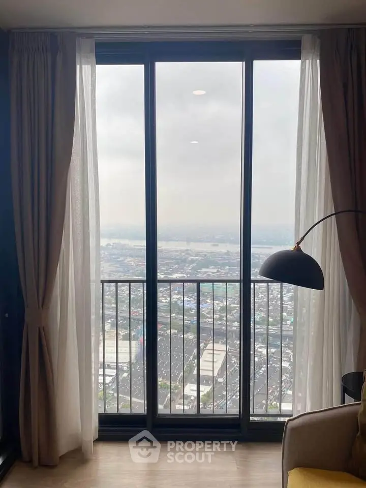 Stunning high-rise apartment with floor-to-ceiling windows offering panoramic city views.
