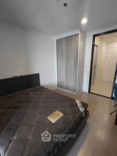 Modern bedroom with sleek design and ample storage in a contemporary apartment.