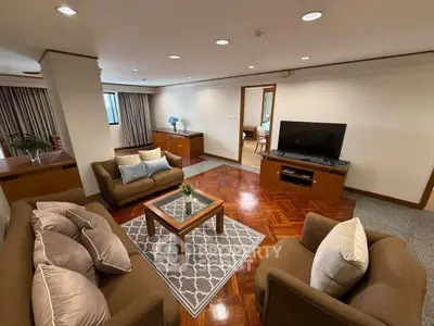 Spacious living room with elegant furniture and hardwood flooring in a modern apartment.