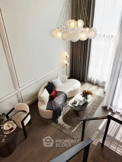 Luxurious modern living room with high ceilings, elegant chandelier, and stylish furniture, perfect for sophisticated living.