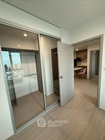 Modern apartment interior with wooden flooring and glass sliding doors