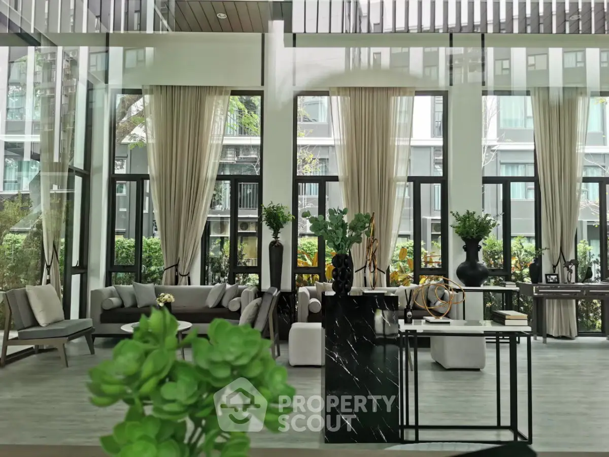 Luxurious modern living room with floor-to-ceiling windows and elegant decor