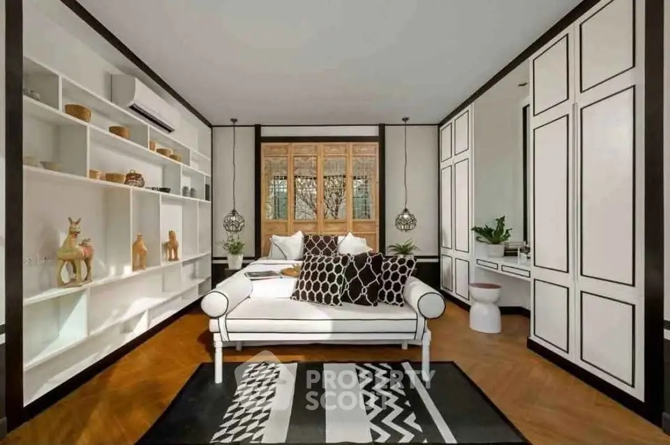 Stylish bedroom with modern decor and ample storage in a cozy home.