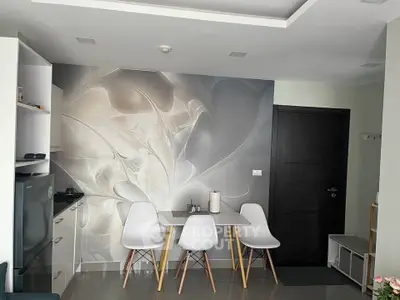 Modern kitchen with stylish dining area and abstract wall art