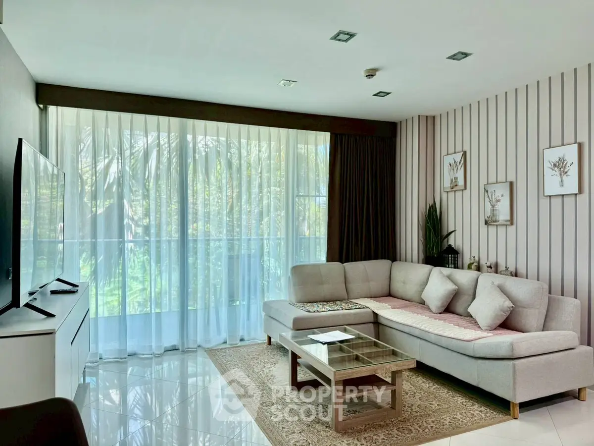 Elegant living room with modern decor and large windows offering natural light