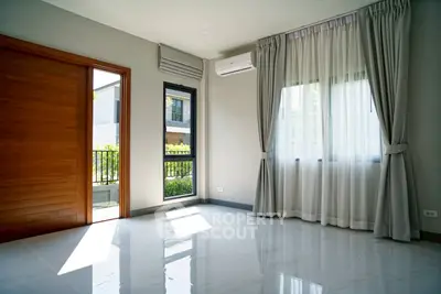 Spacious empty room with large windows and modern air conditioning, perfect for customization.
