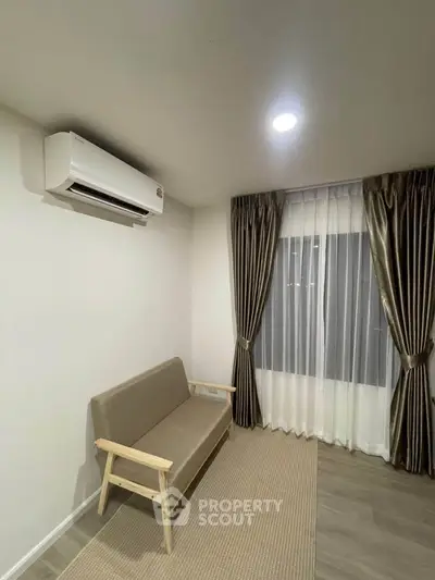 Cozy living room with modern air conditioning and elegant curtains