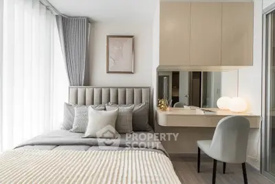 Modern bedroom with stylish decor and natural light, featuring a cozy bed and elegant workspace.