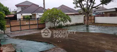 Spacious residential property with paved driveway and lush greenery in a serene neighborhood.