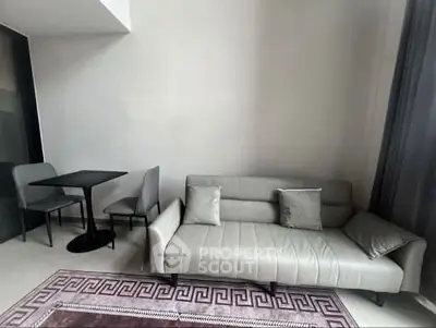 Modern living room with sleek sofa and dining area in stylish apartment