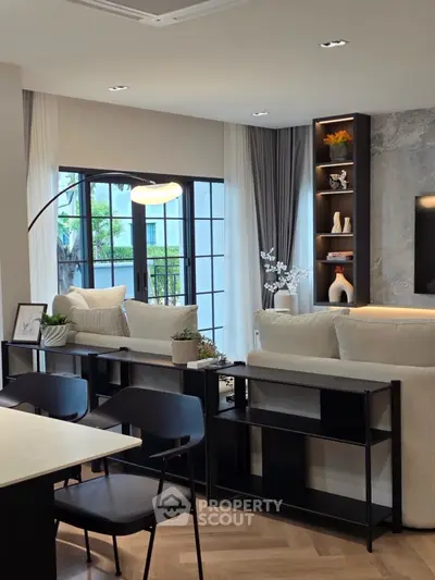 Modern living room with elegant decor and large windows