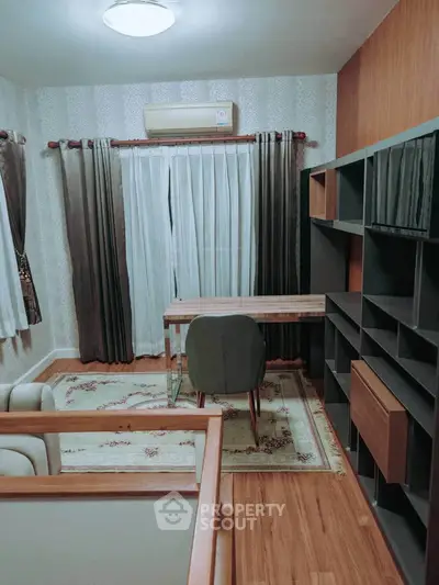 Elegant study room with modern desk and shelving, featuring stylish curtains and air conditioning.