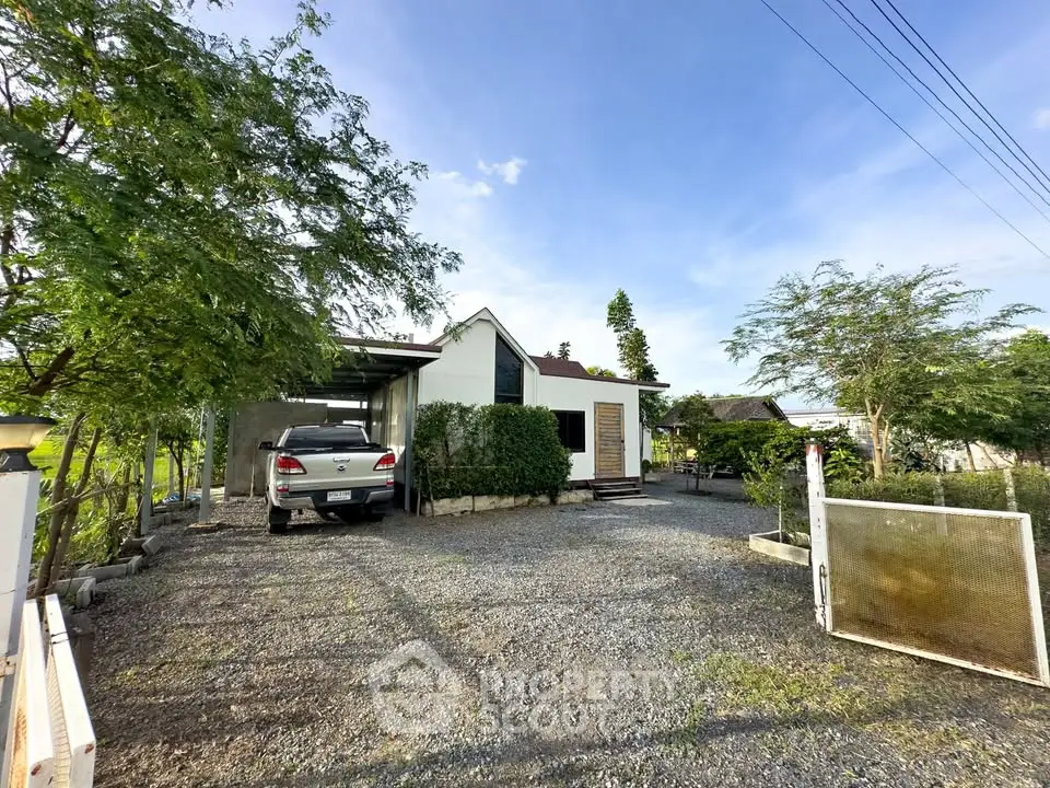 Charming countryside home with spacious driveway and lush greenery, perfect for serene living.