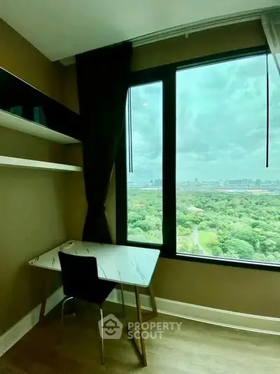 Modern study nook with stunning cityscape view from high-rise window.