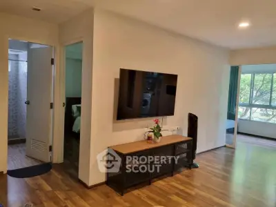 Spacious living room with modern decor and large window view