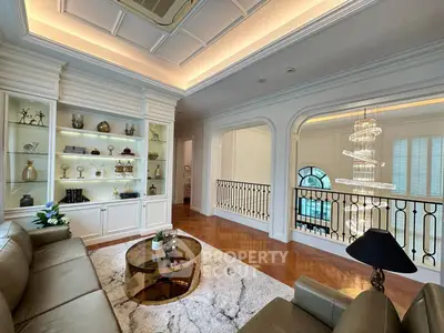 Luxurious living room with elegant decor and stunning chandelier in upscale home