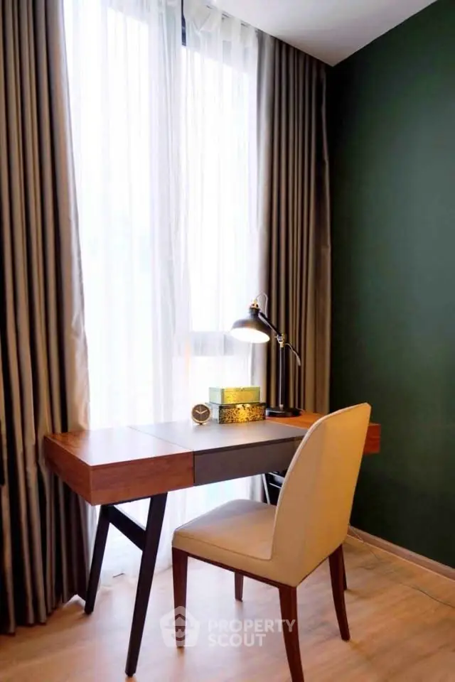 Chic home office with elegant desk and chair by a large window, perfect for productivity and style.