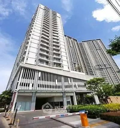 Stunning high-rise condominium with modern architecture and lush surroundings.