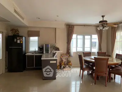 Spacious dining area with modern kitchen and elegant decor