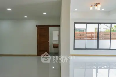 Spacious modern living area with large windows and sleek flooring