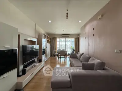 Spacious modern living room with large windows and stylish furniture.