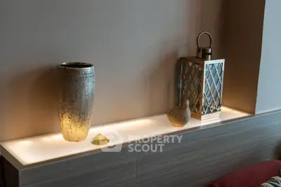 Elegant interior decor with vase and lantern on a modern shelf, enhancing home ambiance.