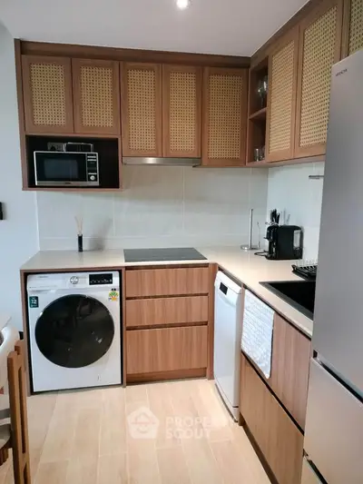 Modern kitchen with wooden cabinets, integrated appliances, and sleek countertops.