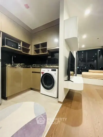 Modern open-layout kitchen with washing machine and sleek design