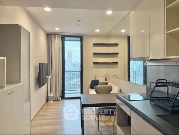 Modern open-plan living room with city view and sleek kitchen design.