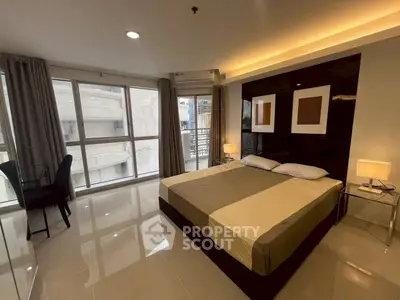 Spacious modern bedroom with large windows and elegant decor