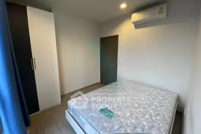 Cozy bedroom with air conditioning and wardrobe, perfect for comfortable living.