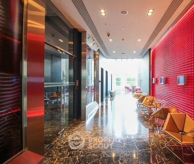 Luxurious modern building lobby with marble floors and stylish seating area.
