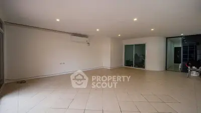 Spacious empty room with tiled flooring and air conditioning unit