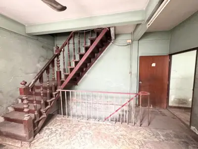 Vintage staircase in an old building with rustic charm and wooden railings.