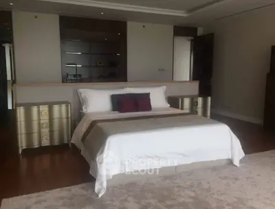 Luxurious bedroom with elegant decor and plush bedding in a modern apartment.