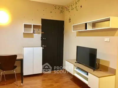 Cozy living room with modern furniture and wall-mounted TV in a stylish apartment.