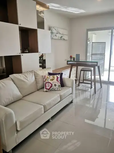 Modern living room with white sofa and stylish decor in a bright apartment.