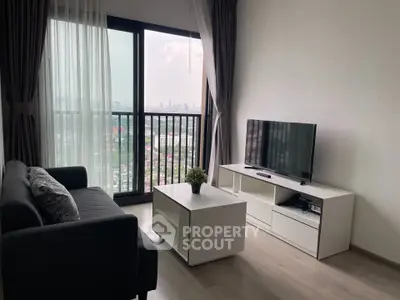 Modern living room with city view, featuring sleek furniture and large windows.