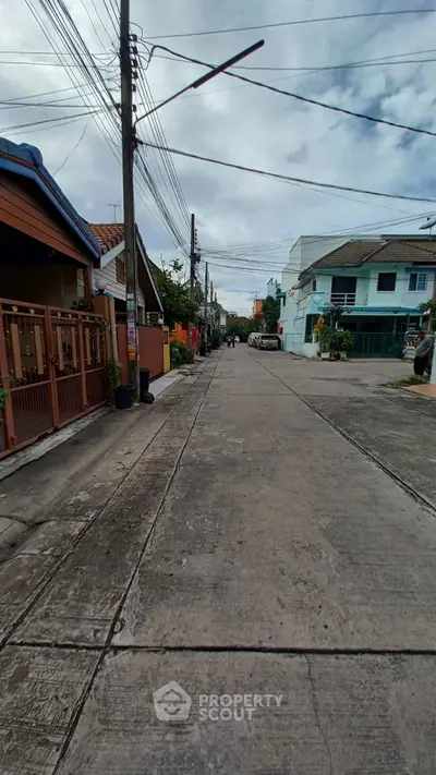 Charming residential street with diverse architecture and lush greenery.