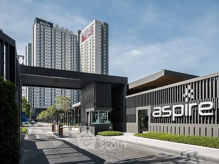 Modern high-rise condominium with sleek design and lush landscaping in urban setting.